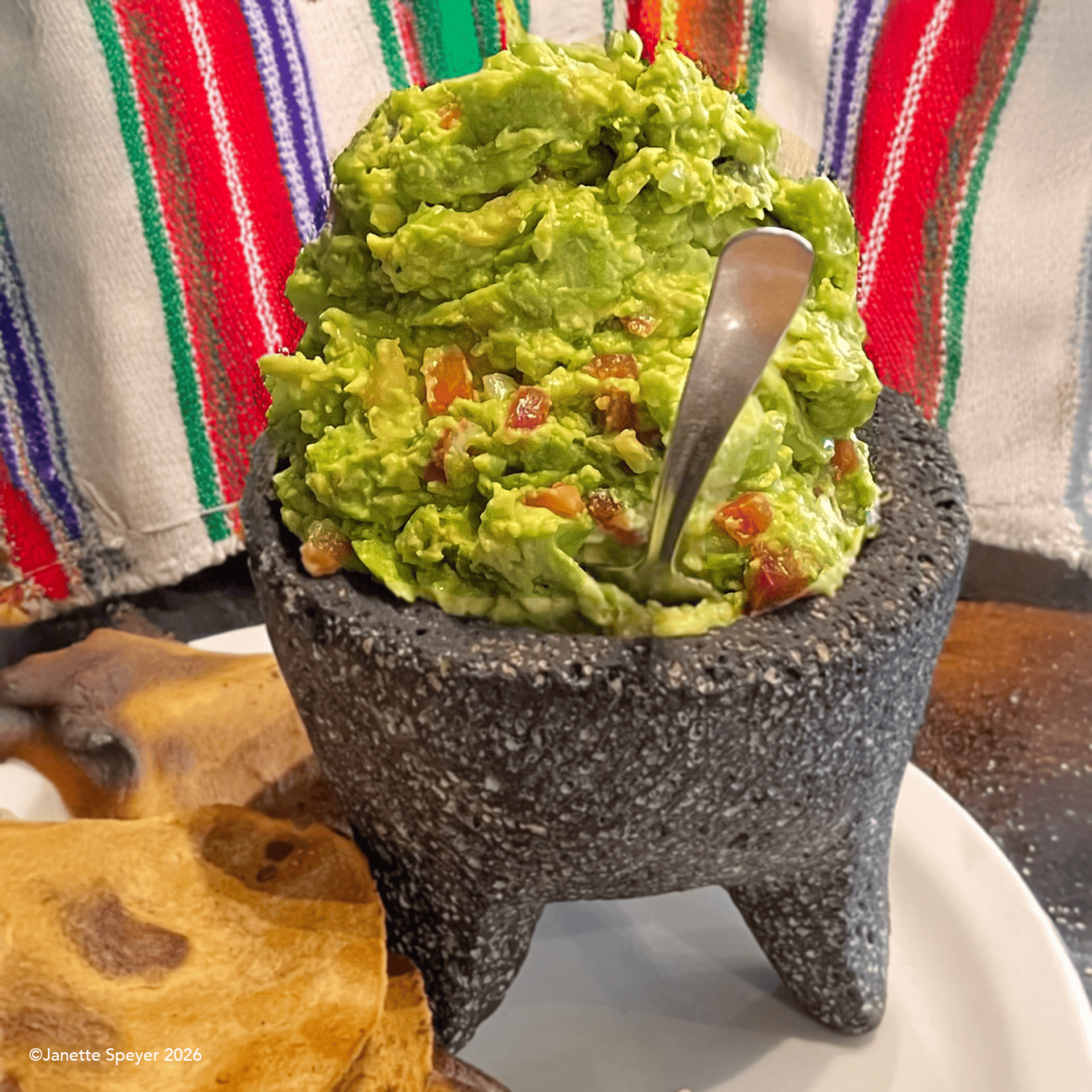 Traditional avocado guacamole in a molcajete